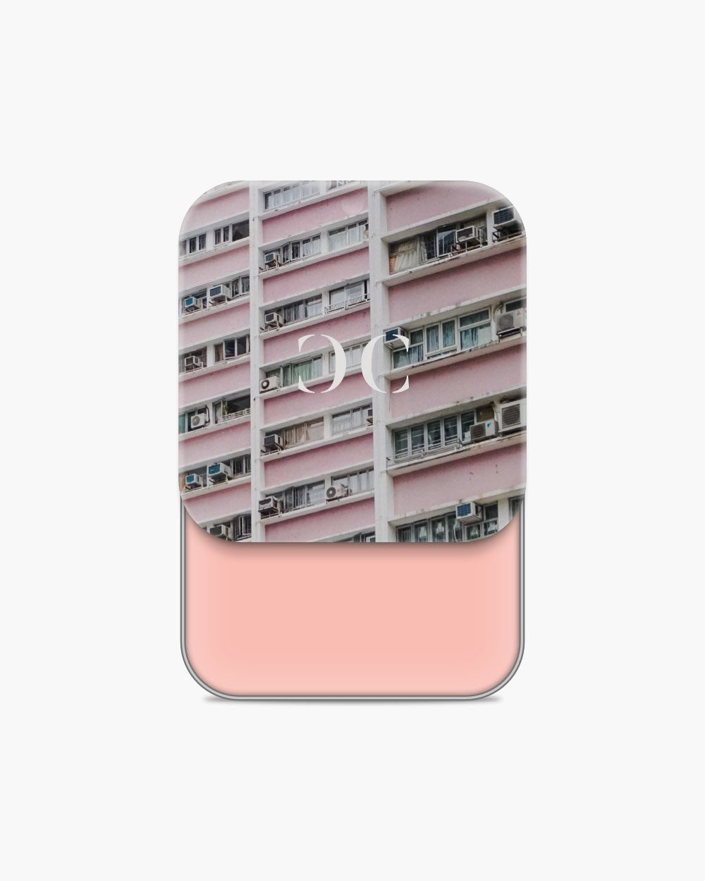 Seint Cream Corrector revealing a light salmon-pink cream below lid art of a pink apartment facade