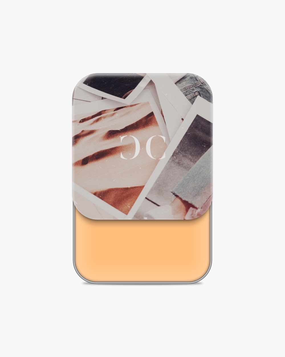 Seint Cream Corrector with warm apricot-orange cream, its lid collaged with scattered photo prints