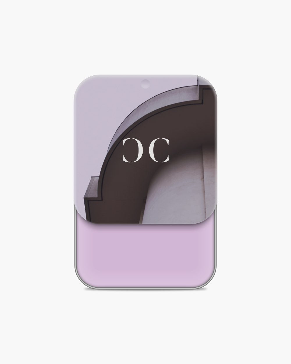Seint Cream Corrector with light lilac-pink cream, its lid showing a curved arch against a lavender wall