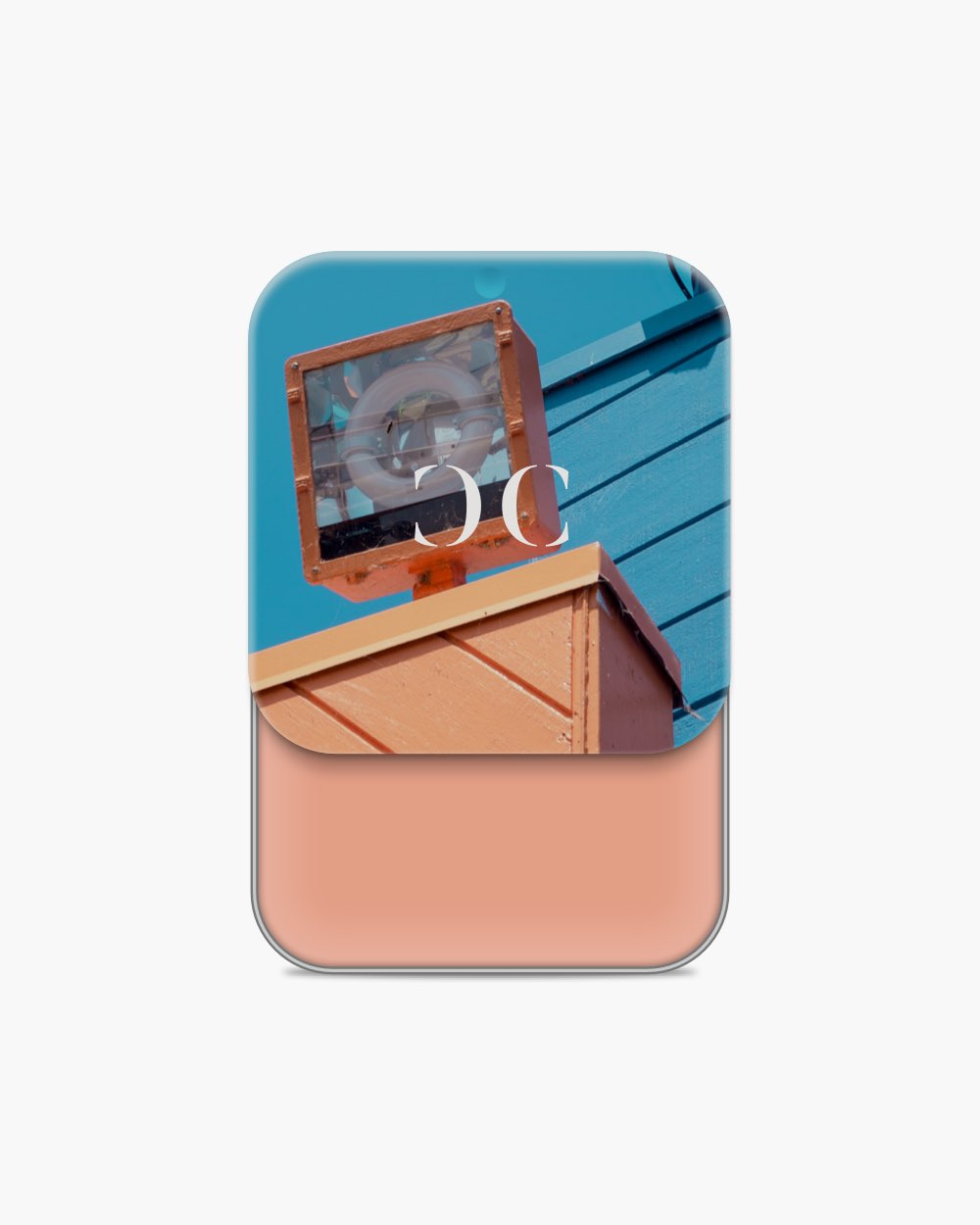 Seint Cream Corrector holding a muted salmon-pink cream, lid printed with an orange floodlight against teal siding