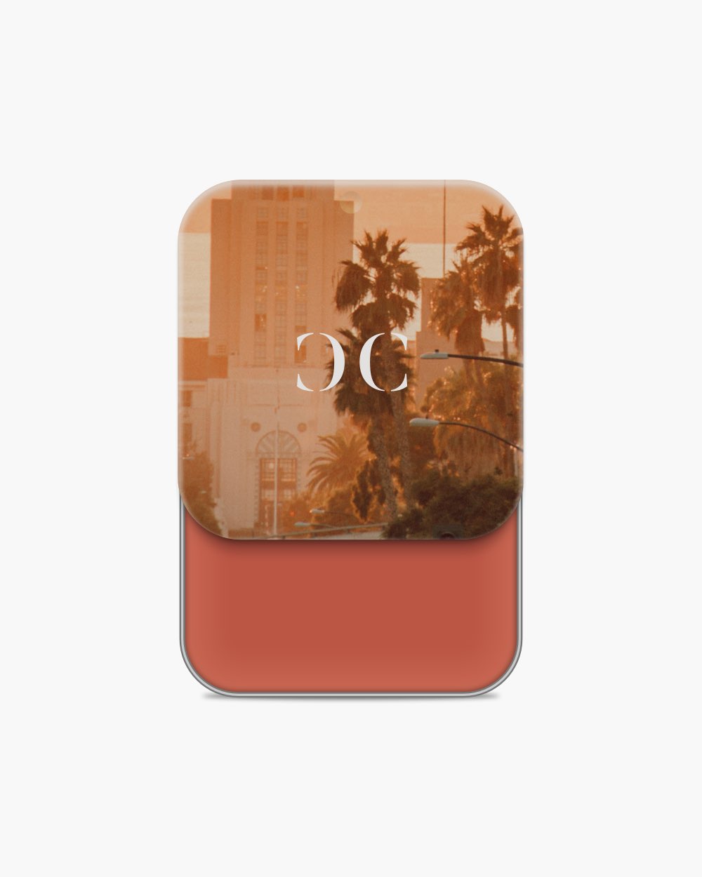 Seint Cream Corrector slid open to a rich terracotta-red cream under sepia lid art of palm trees and a city tower