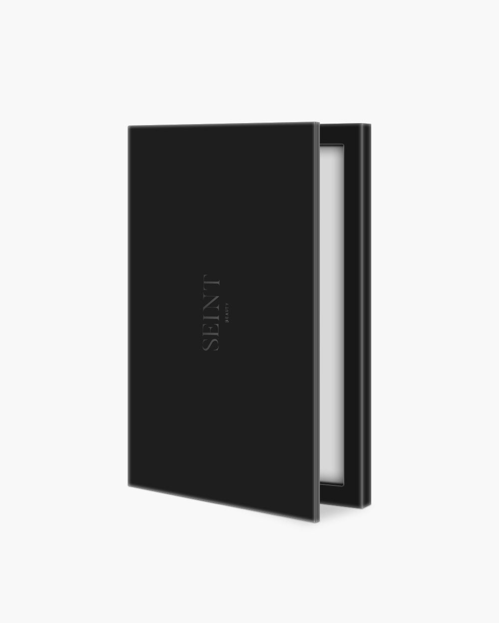 Seint Cream Corrector Palette 12 in sleek matte black with tonal SEINT wordmark, opened a sliver to show the mirror
