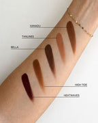 Seint Bronzer arm swatches of Xanadu, Tanlines, Bella, High Tide and Heatwaves on a forearm