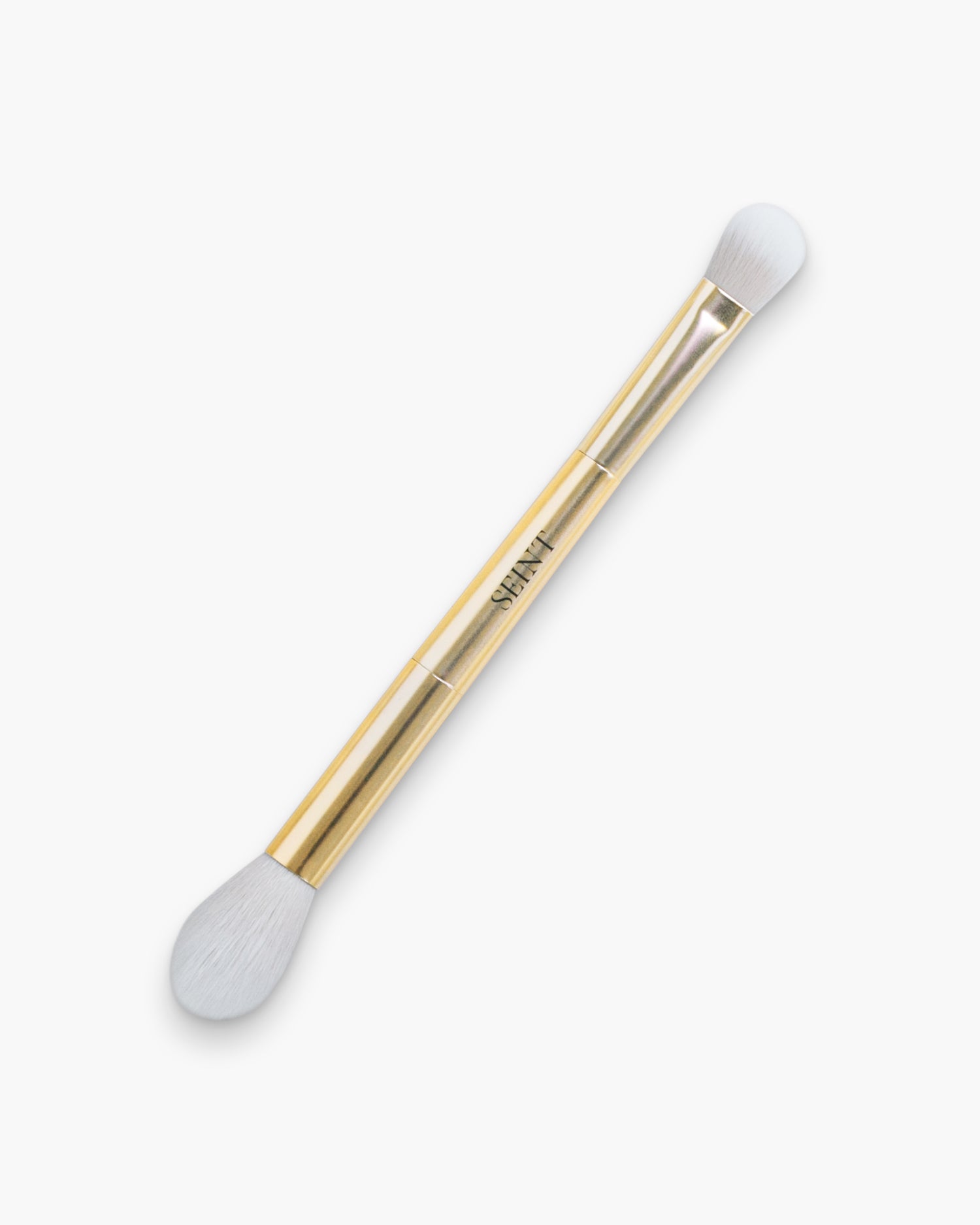 Seint Blend Brush in gold with a large wispy tapered head and a small dense dome end for blurring makeup
