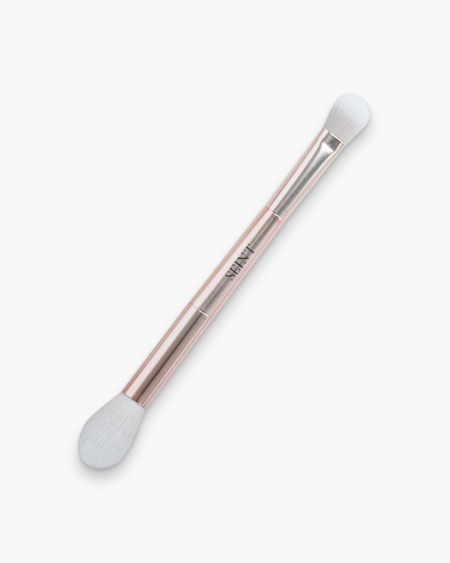 Seint Blend Brush, rose gold finish — double-ended handle pairing a fluffy tapered head with a dense dome tip