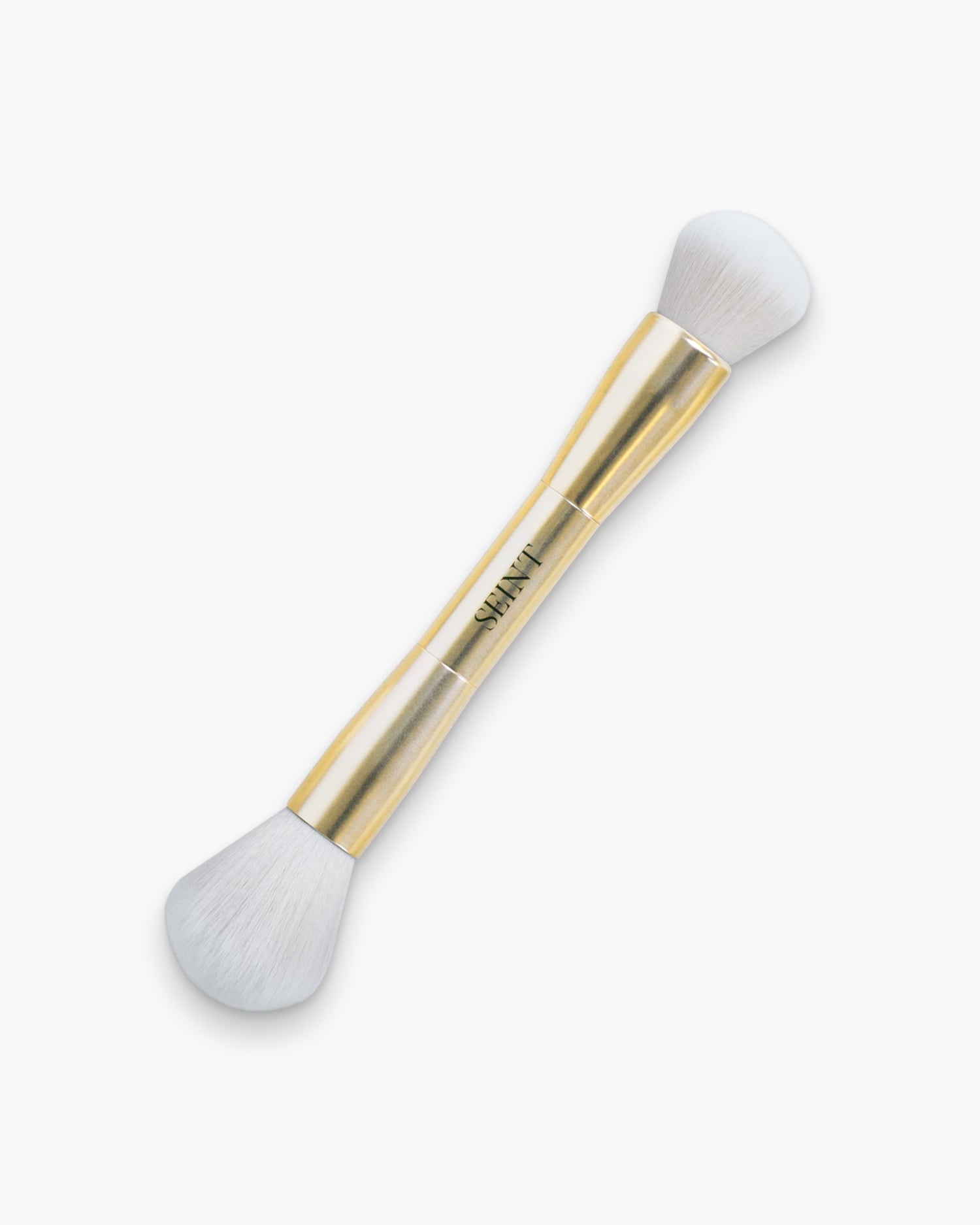 Seint Blush + Bronzer Brush in gold with two fluffy white heads — a full powder end and a smaller rounded end