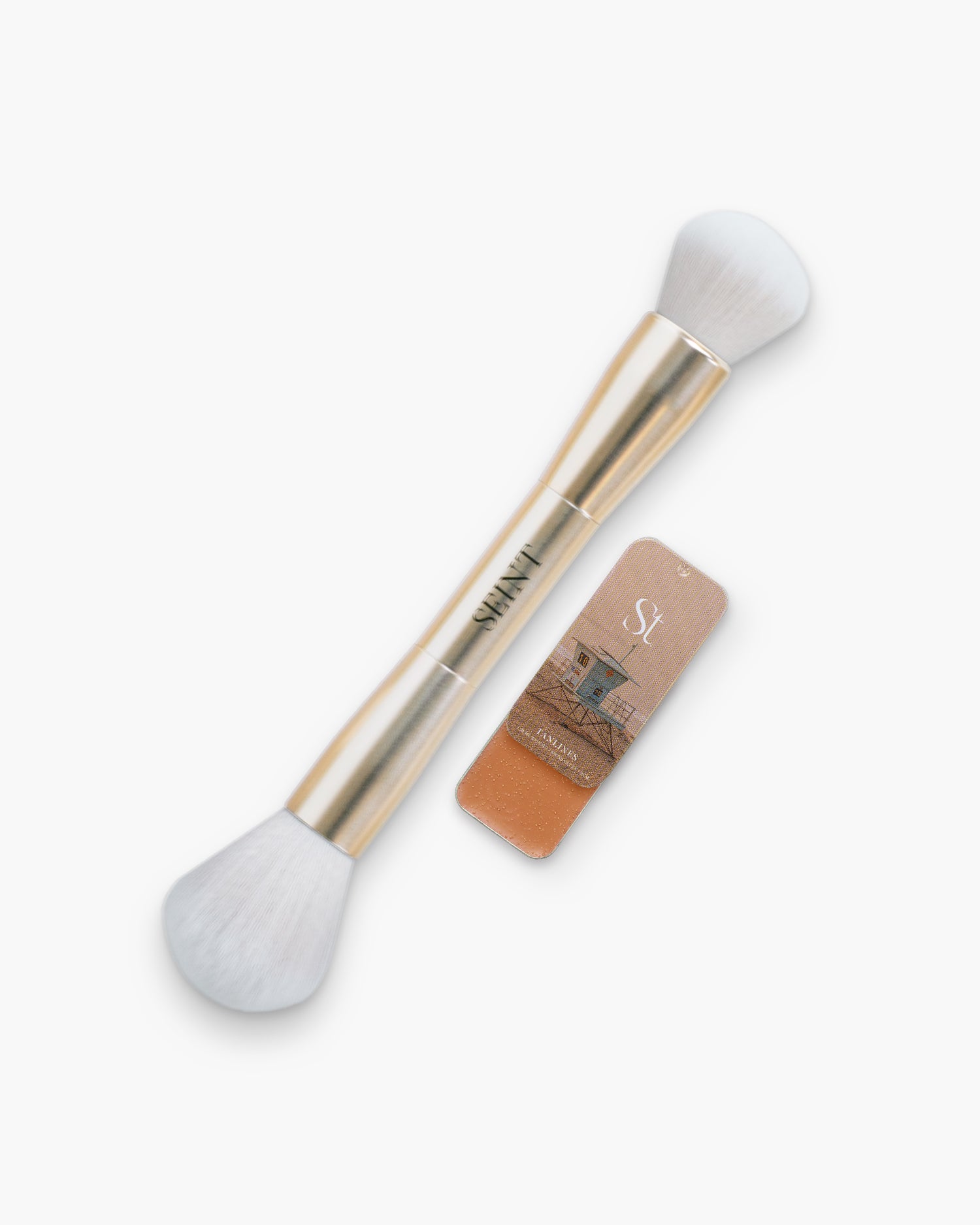 Seint Bronzer Bundle pairing the two-sided gold brush with a Tanlines cream bronzer tin in warm golden tan