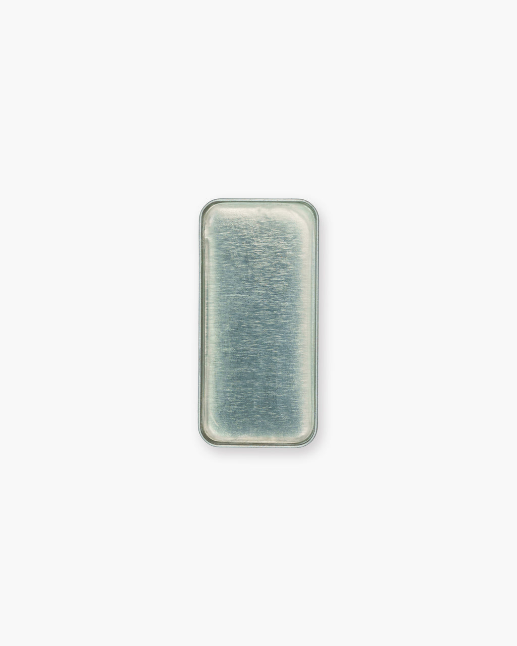 Seint Brow Wax seen from above, the clear colorless wax filling its rectangular metal tray
