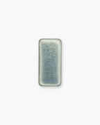 Seint Brow Wax seen from above, the clear colorless wax filling its rectangular metal tray