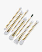 Seint Brush Bundle — seven gold double-ended makeup brushes fanned out, white bristles with one dark spoolie tip
