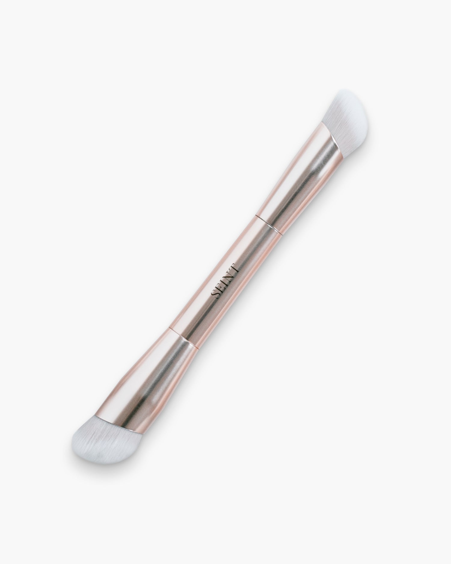Seint Buff Brush shown in rose gold with a wide angled highlight end and a smaller contour end