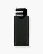 Seint Classic Comb in glossy black tucked into its SEINT-embossed black leather sleeve