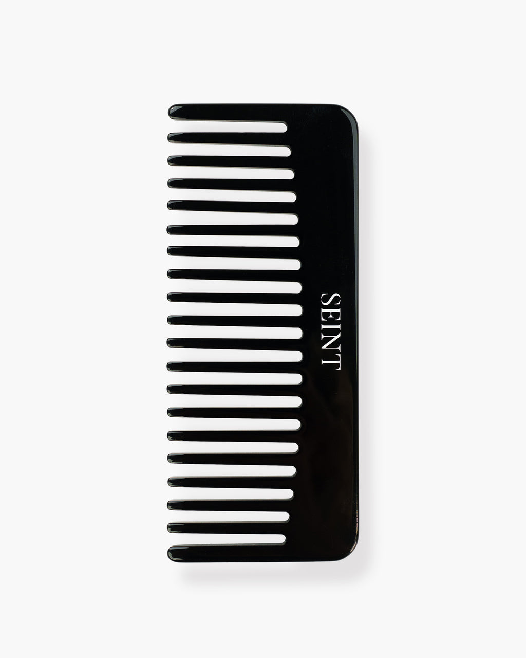 Seint Classic Comb flat lay showing wide glossy black teeth and the SEINT wordmark in white