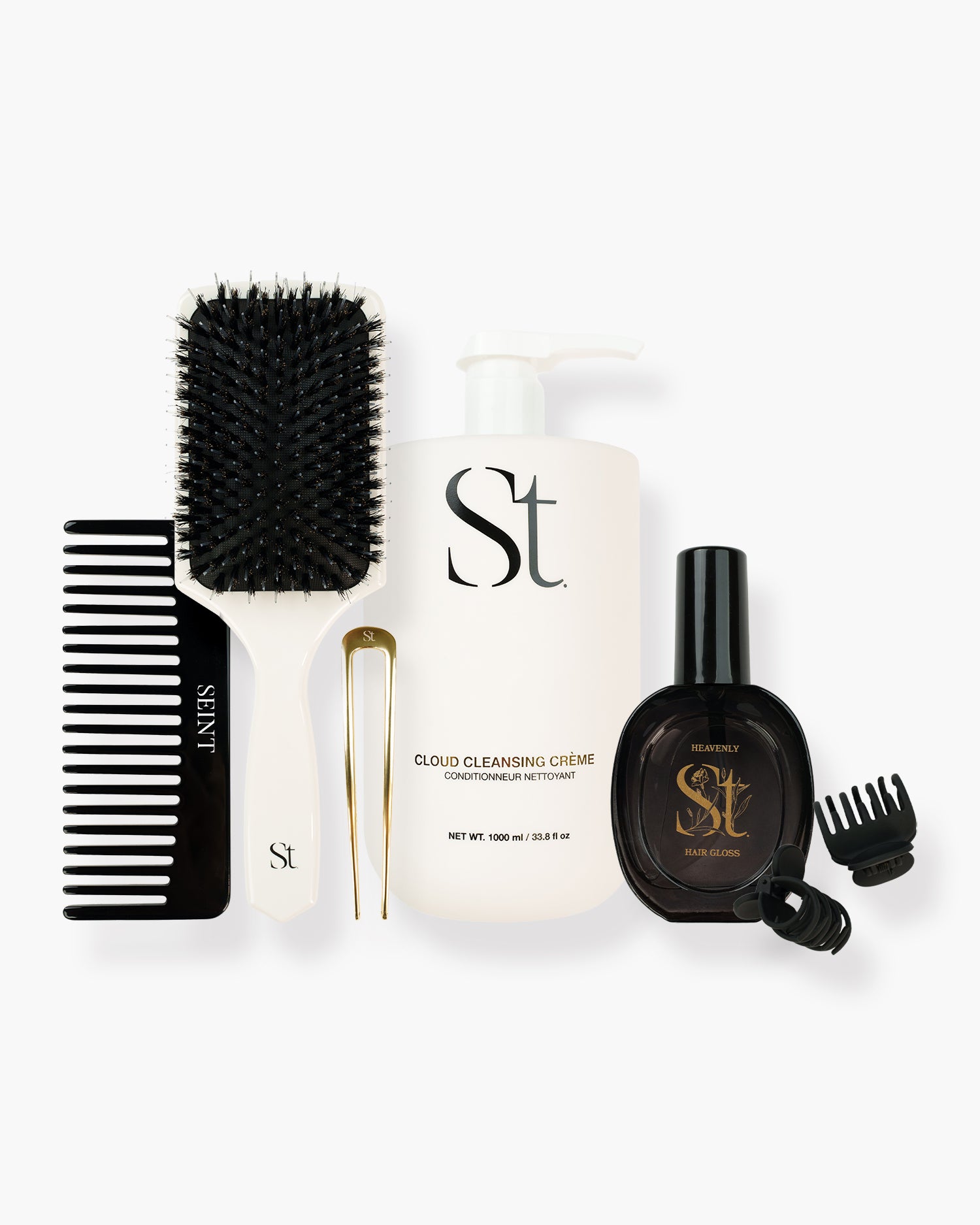 Seint Classic Hair Bundle flat lay: paddle brush, comb, gold hair pin, Cloud Cleansing Crème, Heavenly Hair Gloss, clips