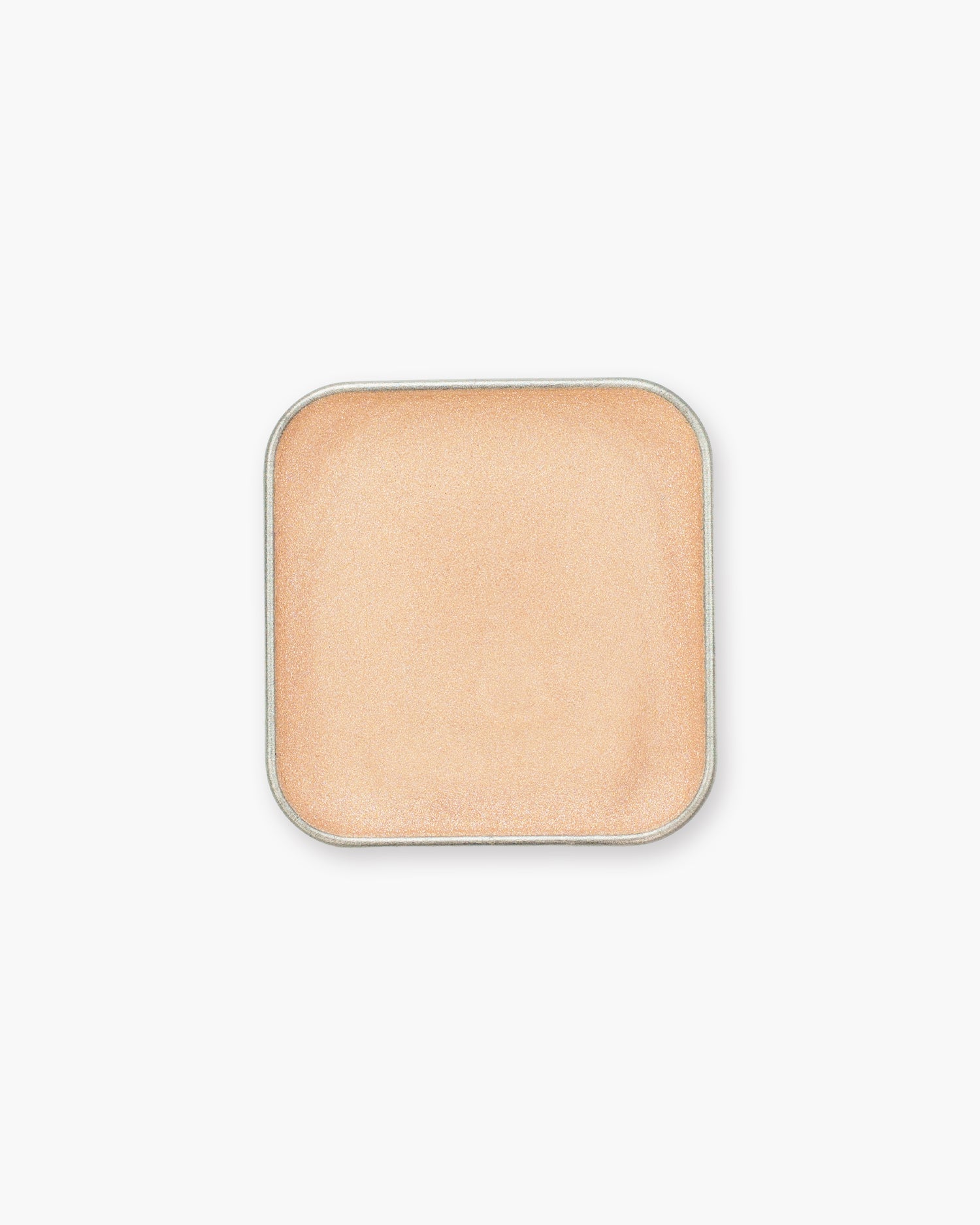 Seint Eyeshadow in Tangled, a smooth cream formula in shimmering peachy champagne