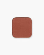 Seint Eyeshadow in Zion, a matte burnt-sienna rust in its square pan