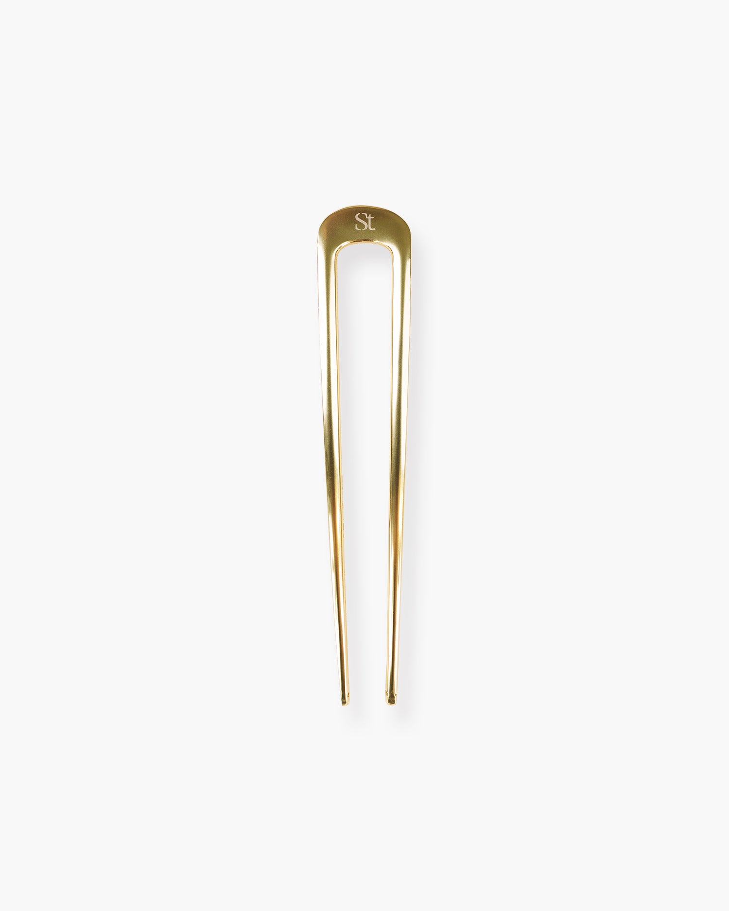 Seint Hair Pin, a polished gold French-style U-shaped pin with engraved wordmark