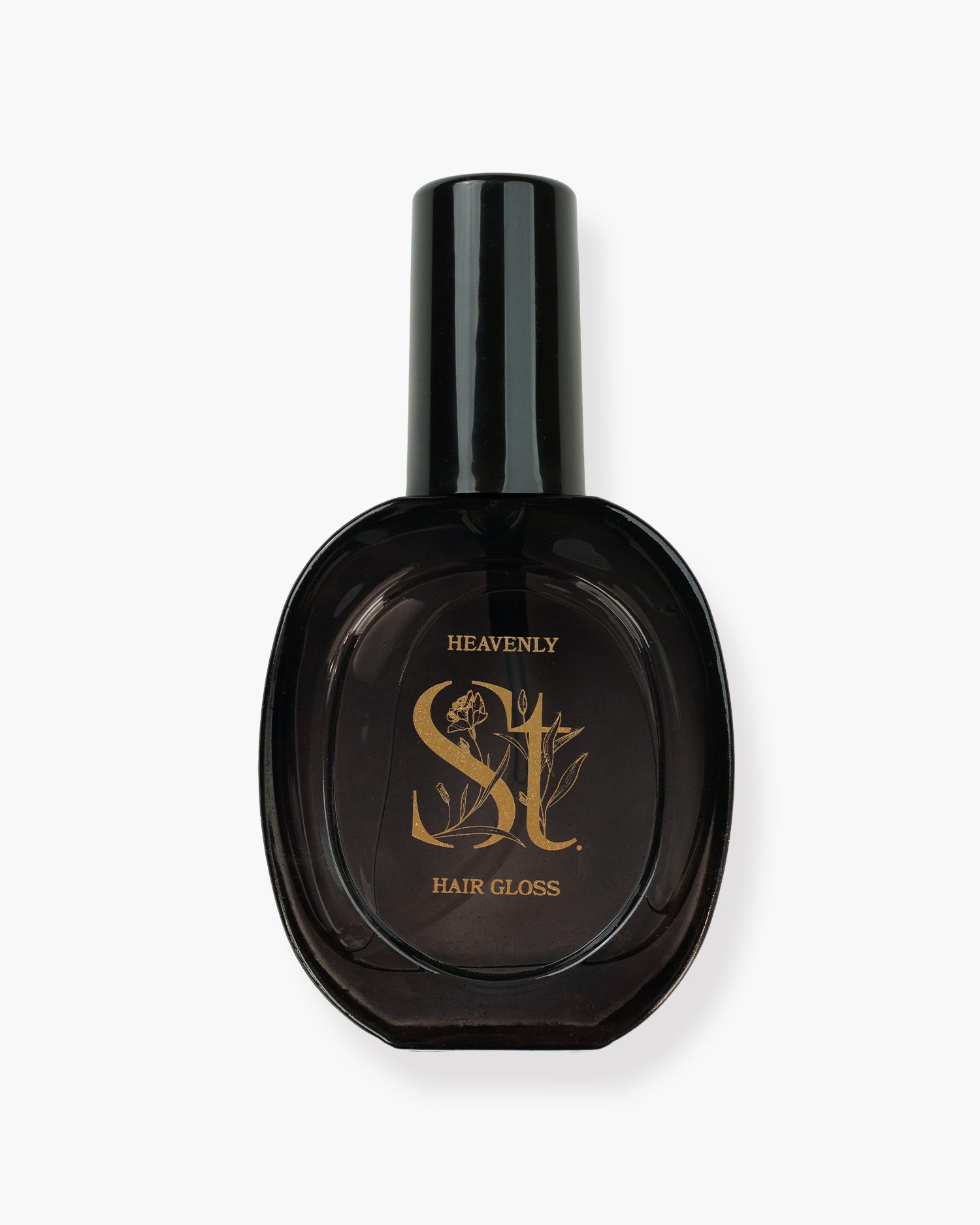 Seint Heavenly Hair Gloss in a dark oval glass bottle with gold floral lettering and a tall black spray cap