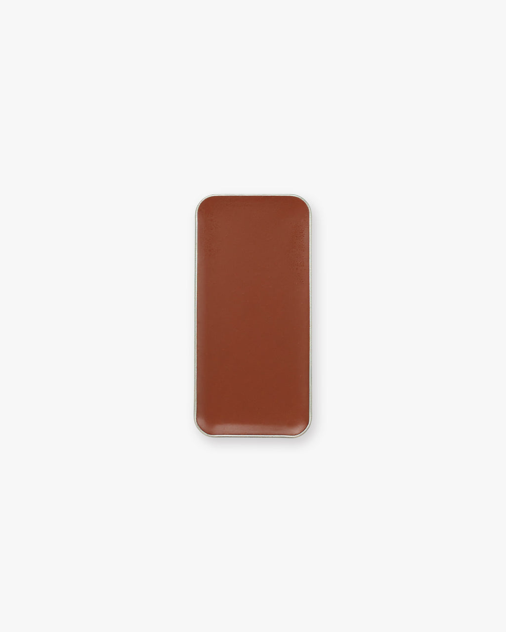 A rectangular pan of brown cream bronzer makeup on a white background.