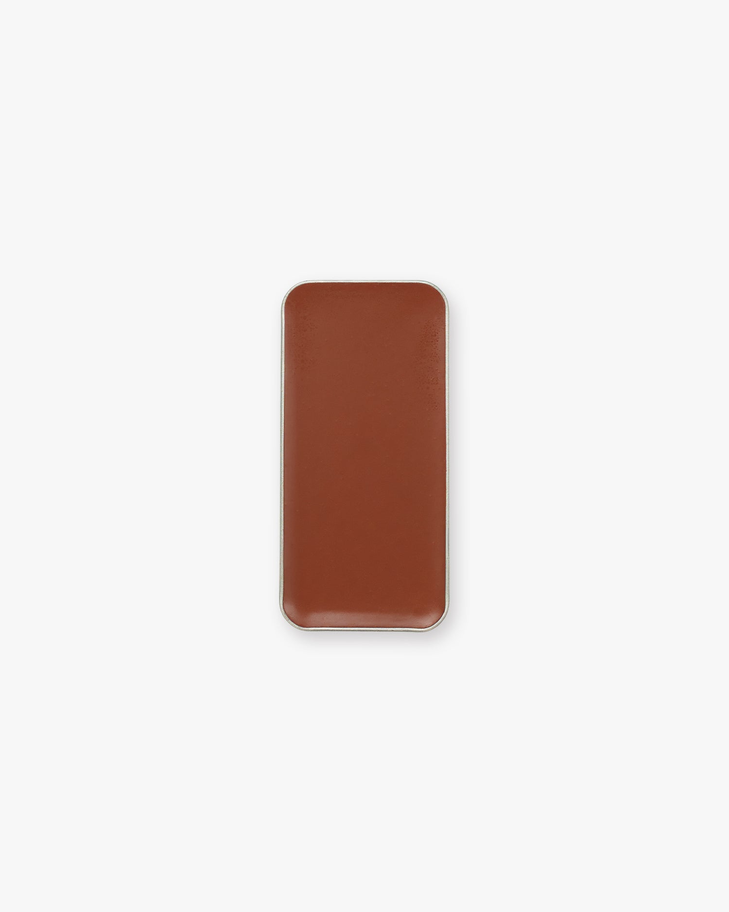 A rectangular pan of brown cream bronzer makeup on a white background.