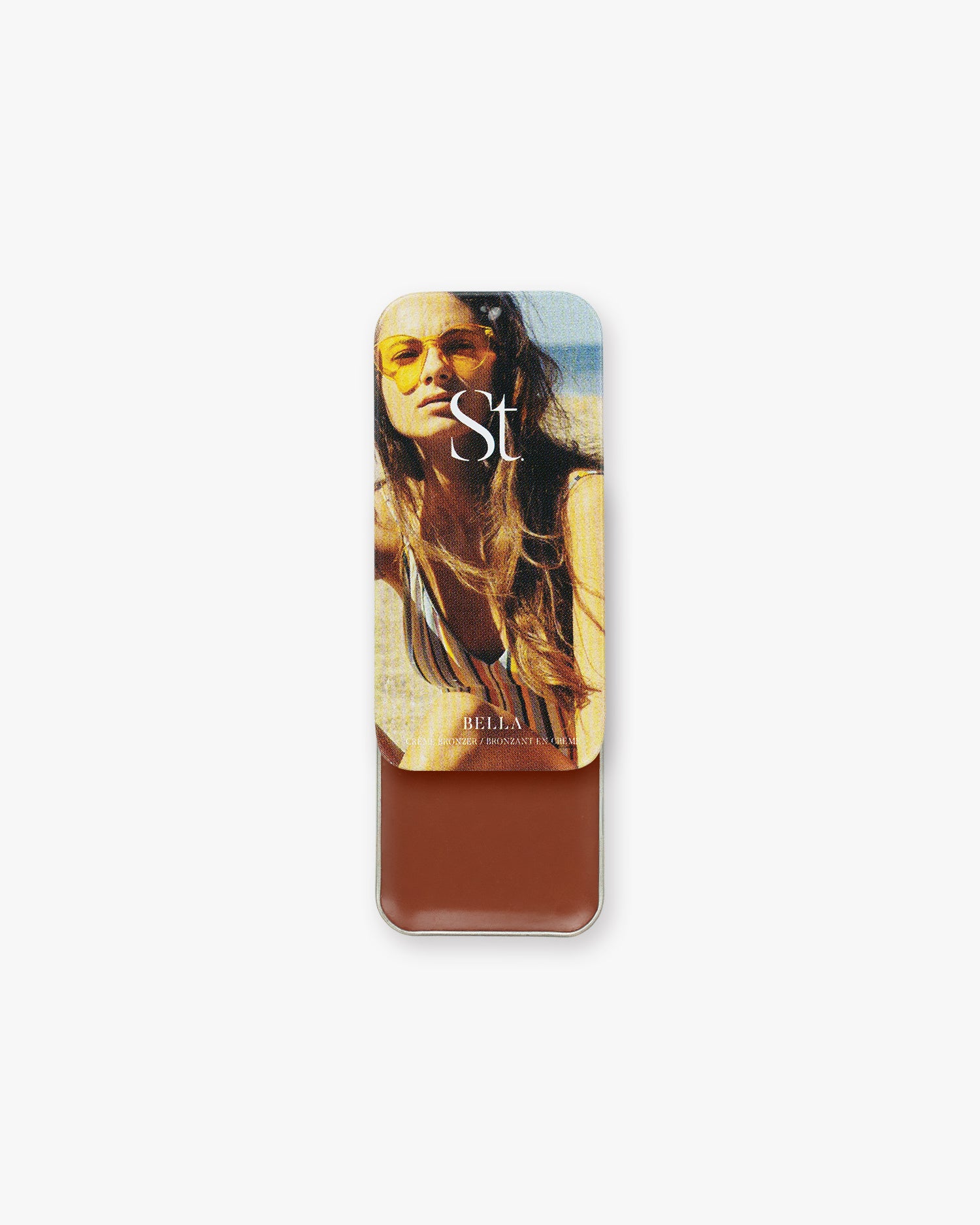 Seint Bronzer in Bella, slide-open tin with beach lid art revealing a warm reddish-brown cream bronzer