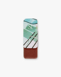 Seint Bronzer in Heatwaves, slide-open tin with retro pool lid art revealing a deep mahogany-brown cream