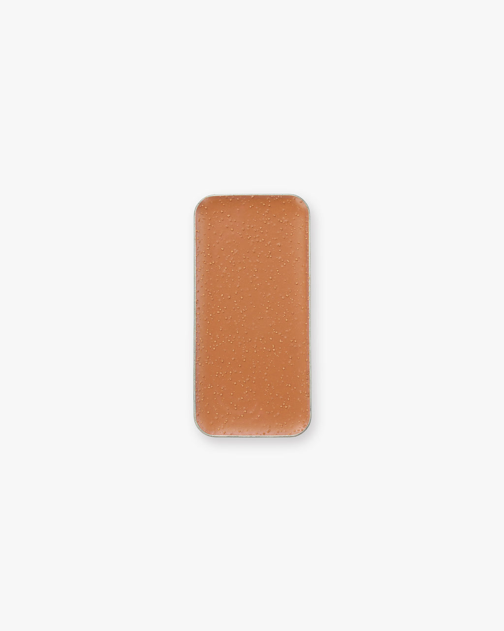 A rectangular pan of orange-brown cream bronzer makeup, set against a white background.