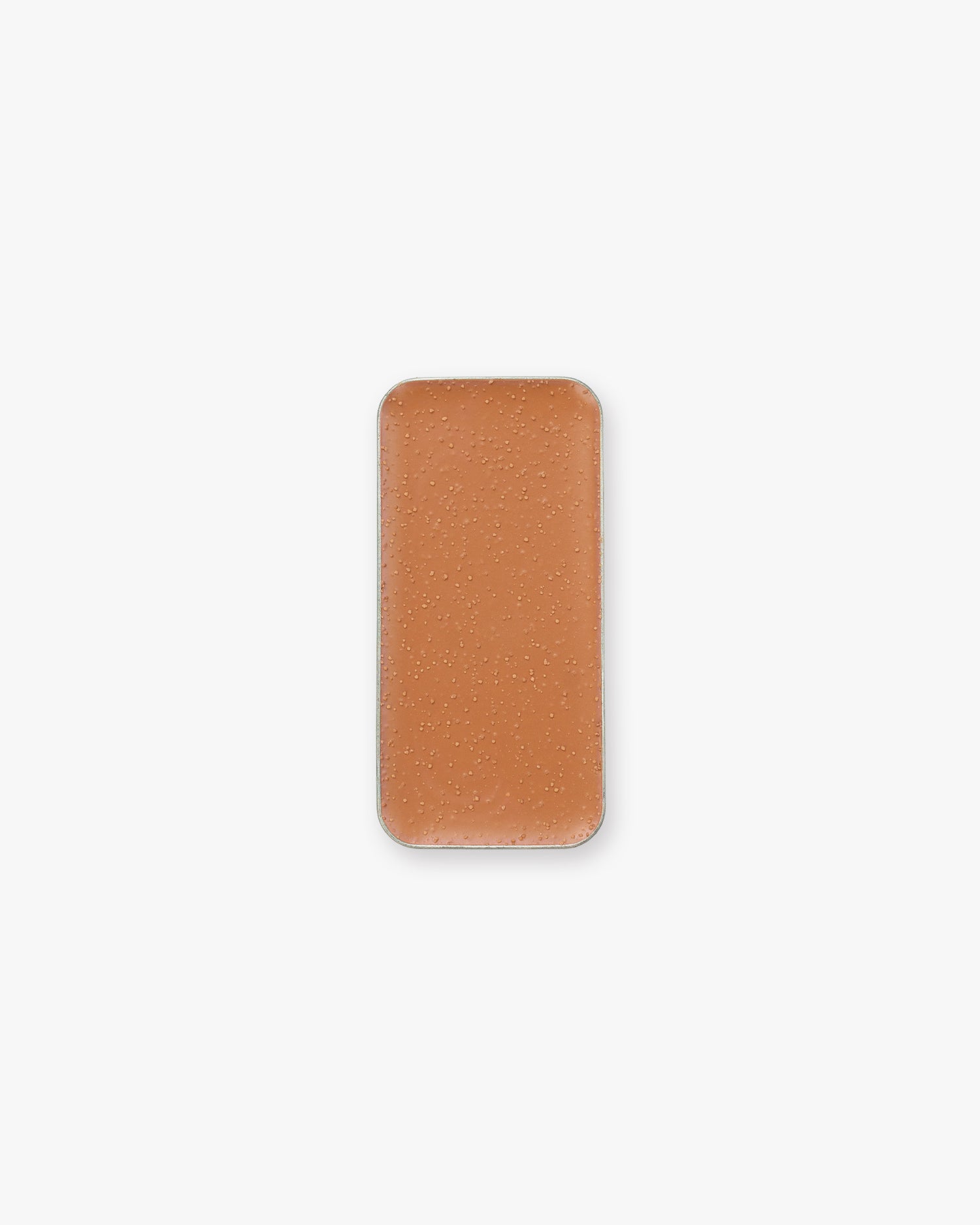 A rectangular pan of orange-brown cream bronzer makeup, set against a white background.