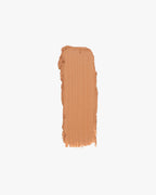A rectangular swatch of light brown cream makeup with uneven edges is centered on a white background.
