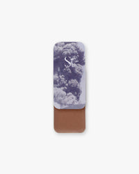 Seint Contour in Ash: billowing ash-cloud lid art over a medium rosy-brown cream in a slide-open tin