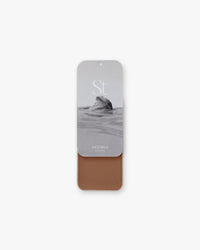 Seint Contour in Astoria: black-and-white sea-rock lid art over a soft rosy-brown cream