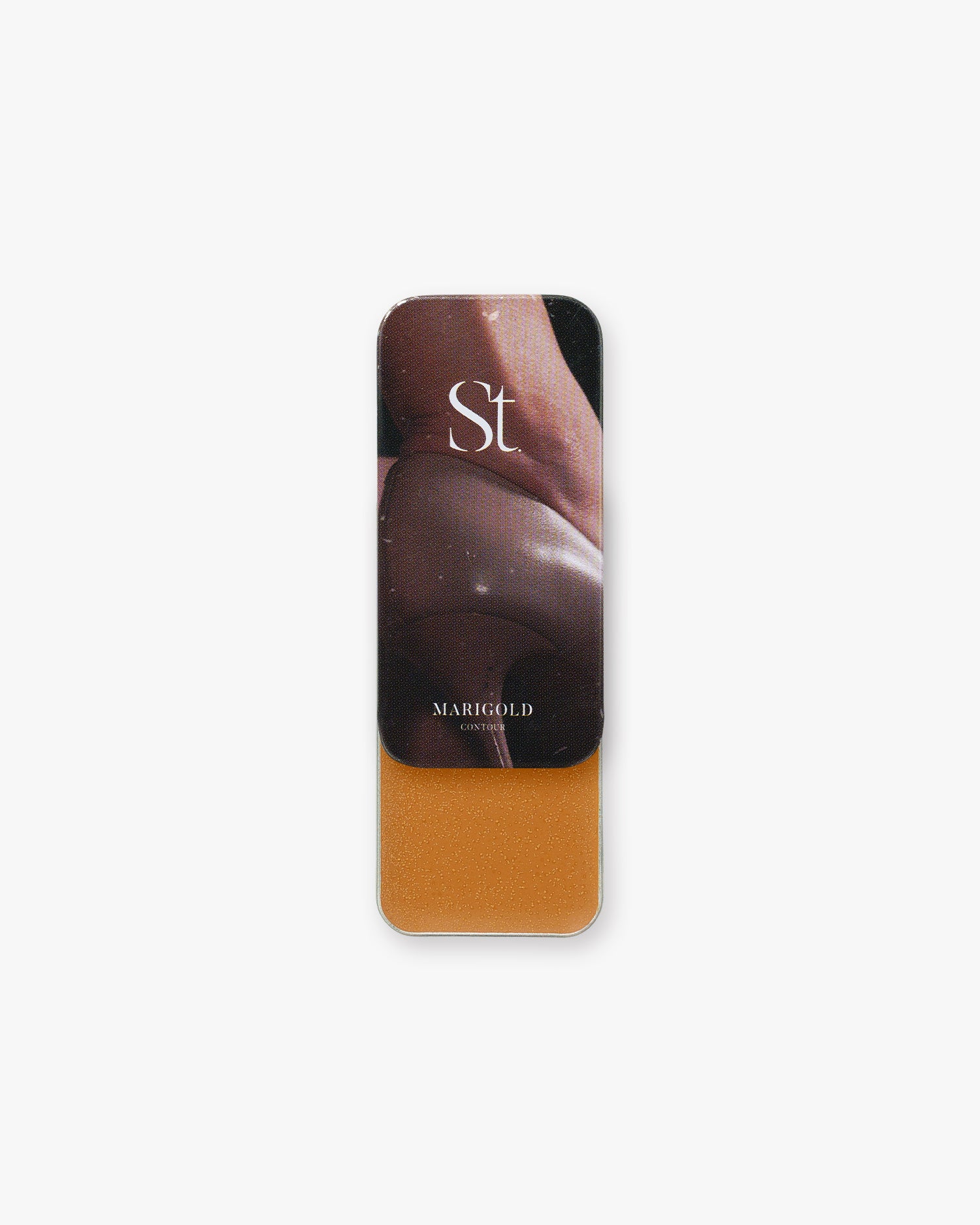 Seint Contour in Marigold: tin opened to a golden amber cream, lid showing a close-up of deep-toned skin