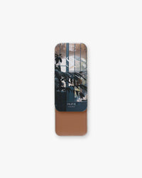 Seint Contour in Olive: slide tin revealing a warm medium-brown cream beneath leafy conservatory window lid art