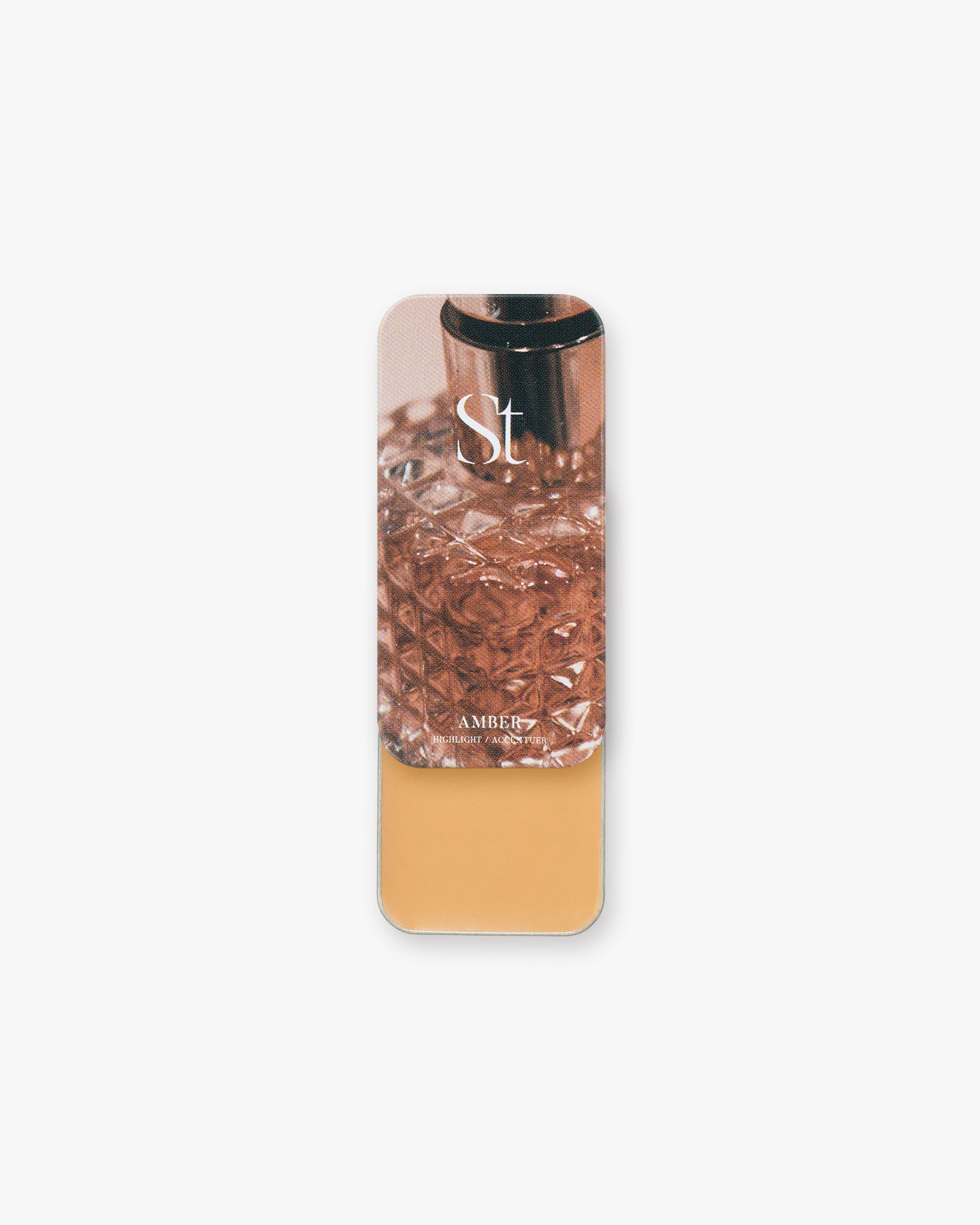 Seint Highlight in Amber: golden caramel cream under a lid with a faceted amber glass perfume bottle