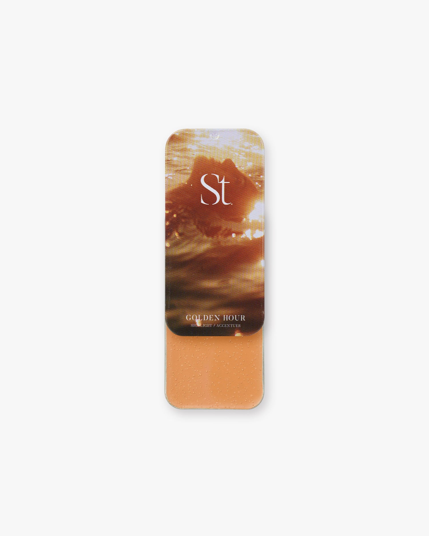 Seint Highlight in Golden Hour, soft amber-orange cream in a tin with sunlit ocean water on the lid