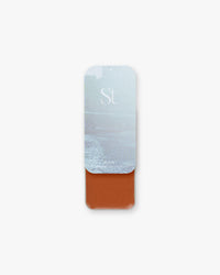 Seint Highlight in Icon, deep rust red-brown cream in a slide tin with a misty ice-blue water lid