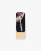 Seint Highlight in Linen, pale warm-ivory cream in a slide tin, lid showing powder sprinkling from a hand