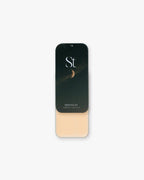 Seint Highlight in Moonlit: open tin of light peachy-beige cream under a night-sky lid with a crescent moon