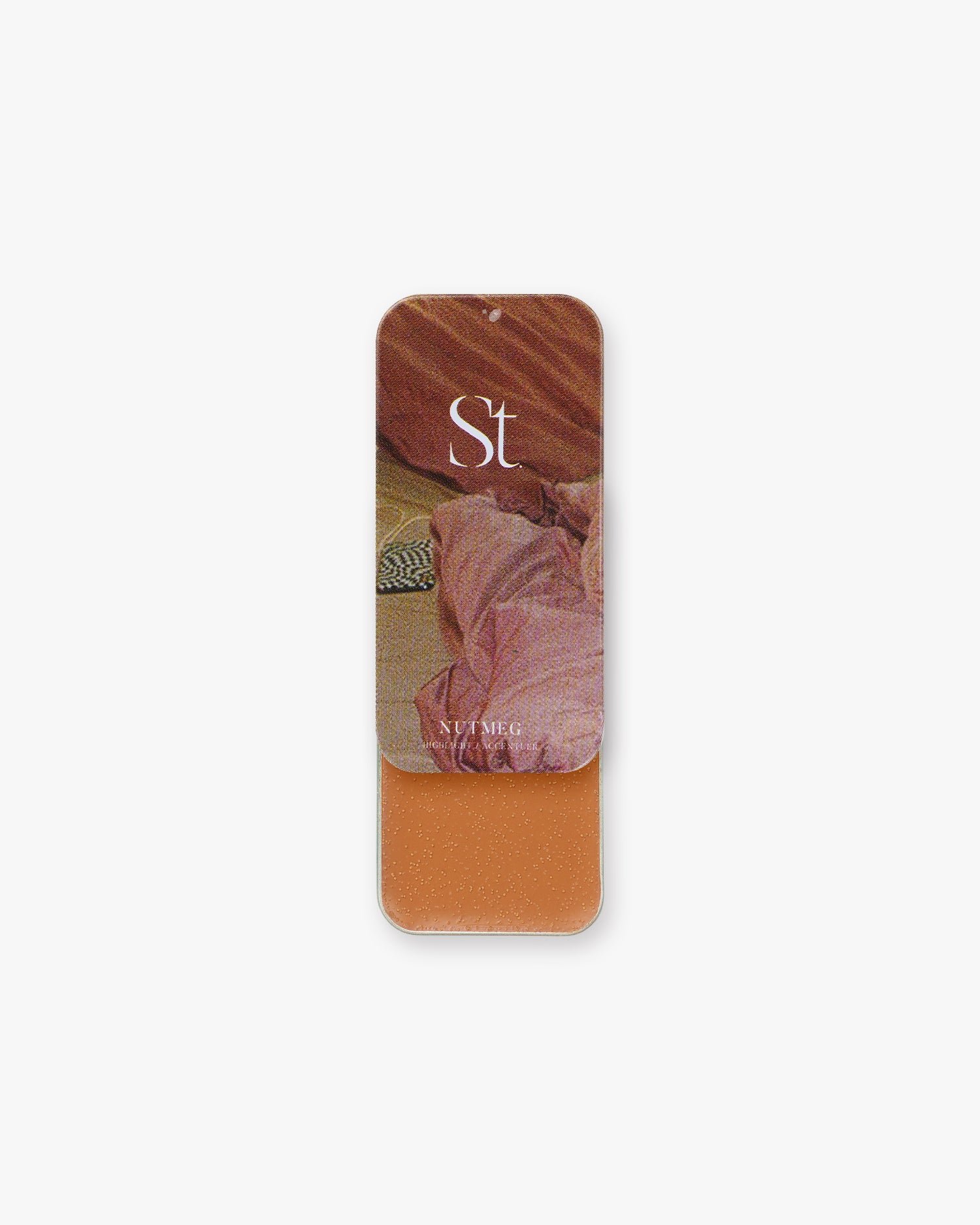 Seint Highlight in Nutmeg, terracotta-brown cream in an open tin, lid showing rumpled rust and pink satin
