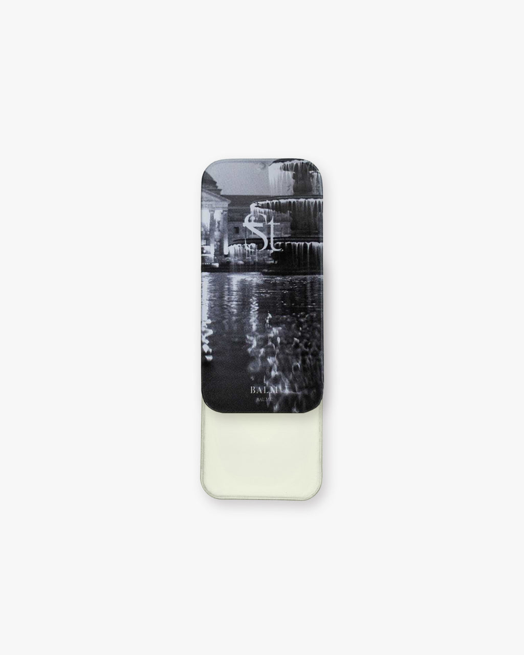 Seint Balm - Unscented slim metal tin slid open to pale ivory balm, lid printed with a black-and-white fountain scene