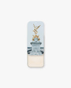 Seint Illuminator in Pearl, tin slid open to soft ivory cream beneath lid art of a gilded winged statue