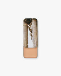 Seint Illuminator in Rose Gold, open tin showing soft pink-champagne cream under classical column lid art