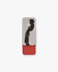 Seint Lip + Cheek in Saffron, satin finish — open tin of warm poppy-red cream for lips and cheeks