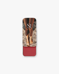 Seint Lip + Cheek in Sangria, satin finish — deep berry-red cream blush shown in its slide-open tin