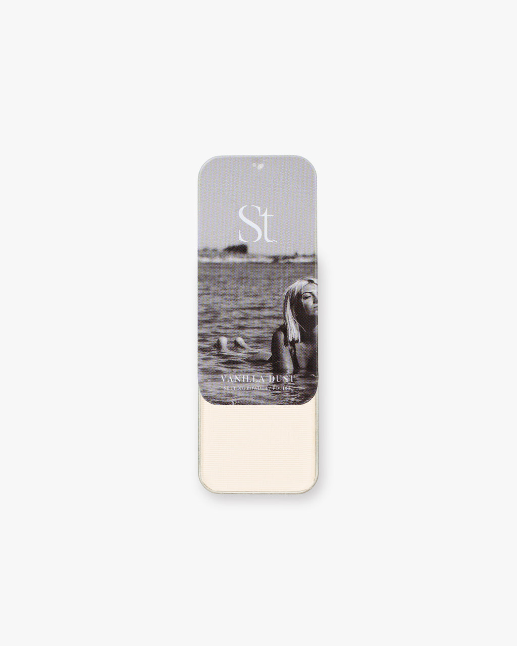 Seint Setting Powder tin in Vanilla Dust slid open to reveal soft ivory powder beneath a black-and-white beach lid