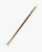 Seint Lash Brush in gold — double-ended with a fanned mascara brush and tapered eyeliner tip in white bristles