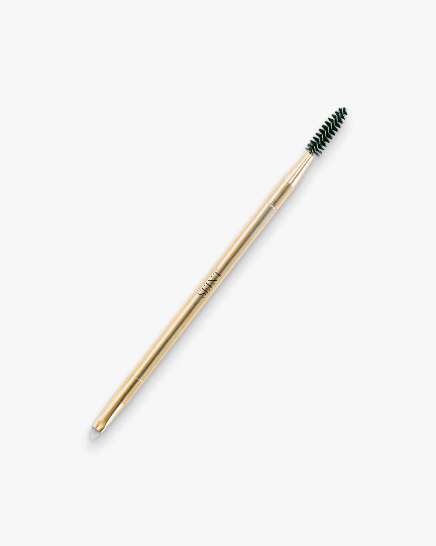 Seint Line Brush in gold — double-ended tool with black spoolie and angled liner tip, SEINT etched on the handle