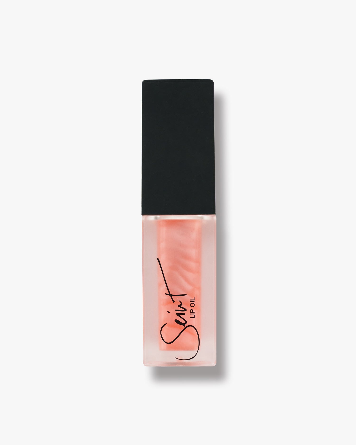 Seint Lip Oil in Chai, soft pearly peach oil with a visible shimmer swirl in the frosted bottle