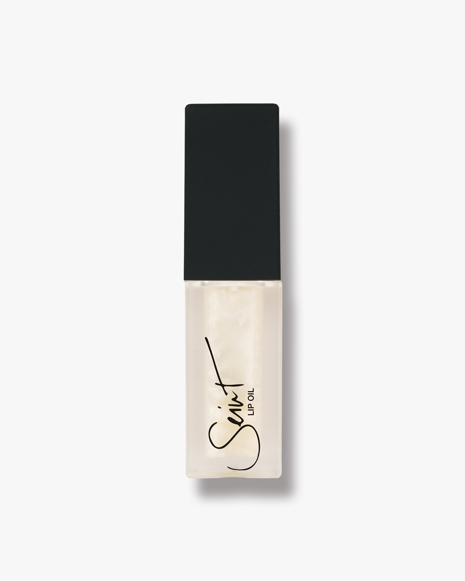 Seint Lip Oil in Marshmallow, creamy ivory-white oil in a frosted bottle with matte black cap