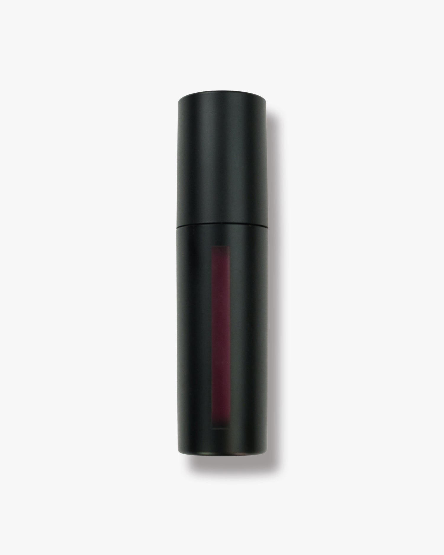 Seint Lip Tint in Berry: deep plum-wine liquid visible through the narrow window of the matte black bottle